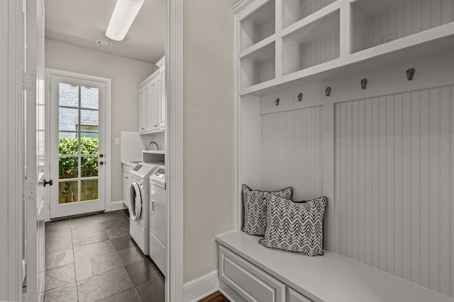 laundry area with cabinet space, washer and dryer, and baseboards