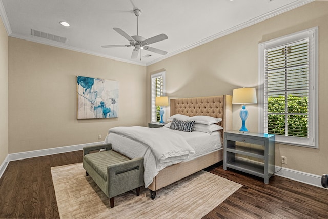 bedroom with wood finished floors, visible vents, multiple windows, and ornamental molding