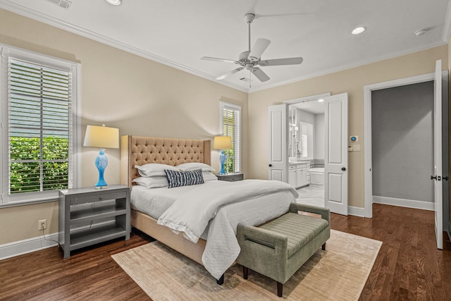 bedroom featuring connected bathroom, baseboards, wood finished floors, and ornamental molding