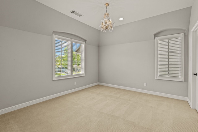 unfurnished room with visible vents, baseboards, light colored carpet, recessed lighting, and an inviting chandelier