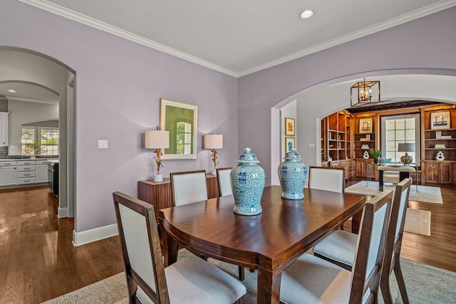 dining room featuring baseboards, recessed lighting, dark wood-style flooring, ornamental molding, and a chandelier