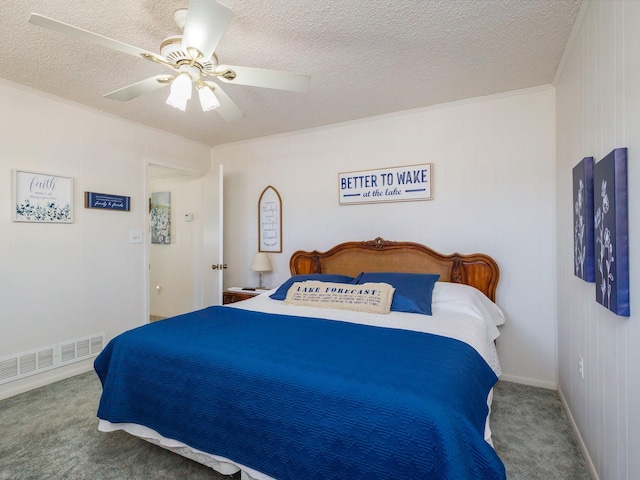 carpeted bedroom featuring a textured ceiling, ornamental molding, visible vents, and a ceiling fan