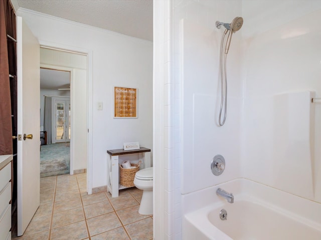 bathroom featuring toilet, shower / bathtub combination, a textured ceiling, and tile patterned floors