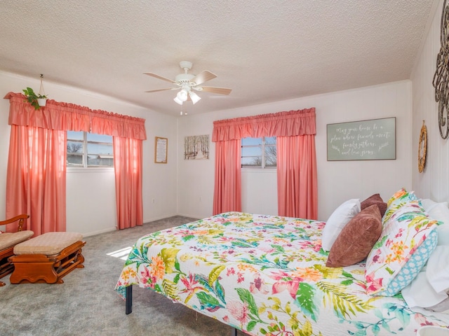 bedroom featuring carpet floors, ceiling fan, and a textured ceiling