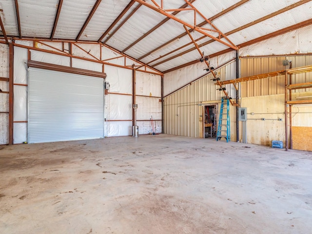 garage with electric panel and metal wall