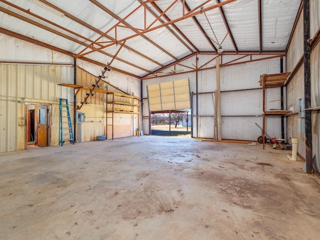 garage featuring electric panel and metal wall