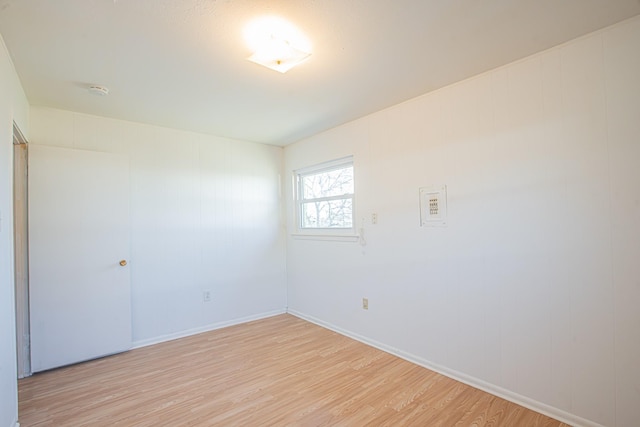 unfurnished room featuring light wood finished floors and baseboards