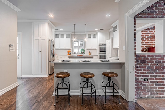 kitchen with dark wood finished floors, white cabinets, glass insert cabinets, a peninsula, and stainless steel appliances