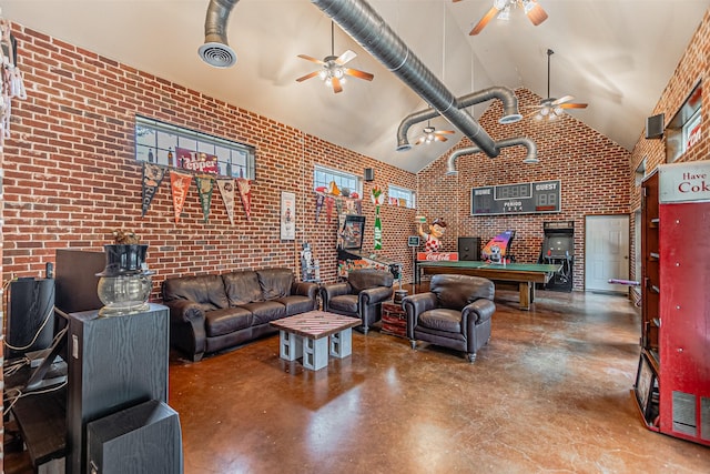 living area with pool table, a ceiling fan, brick wall, high vaulted ceiling, and concrete floors