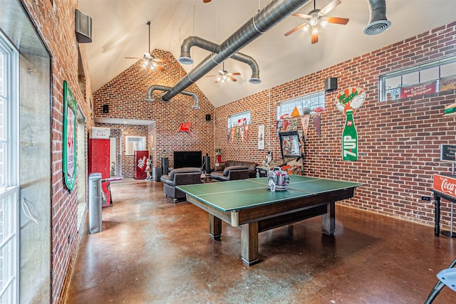 rec room with finished concrete flooring, high vaulted ceiling, brick wall, and visible vents