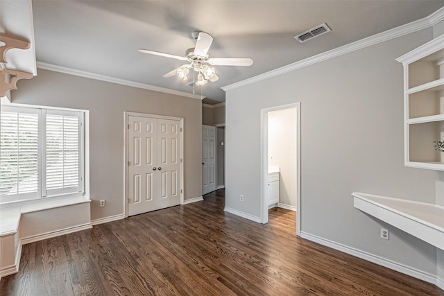 unfurnished bedroom featuring baseboards, crown molding, visible vents, and dark wood-type flooring