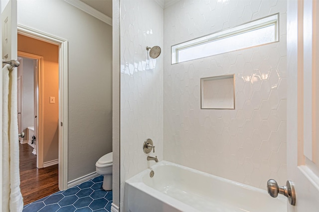 full bath with baseboards, toilet, tile patterned floors, crown molding, and shower / bathing tub combination