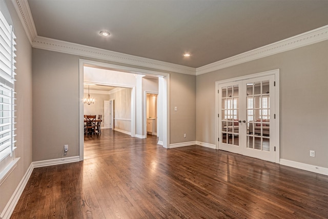 unfurnished room with ornamental molding, french doors, dark wood-type flooring, and baseboards