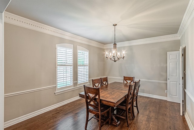 dining area with dark wood-style floors, crown molding, baseboards, and an inviting chandelier