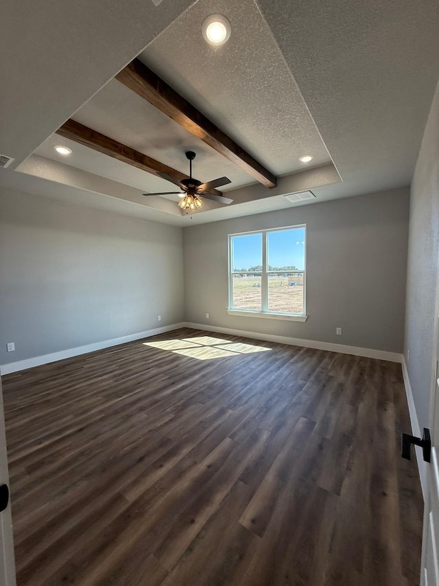 unfurnished room with dark wood-style flooring, beamed ceiling, and baseboards