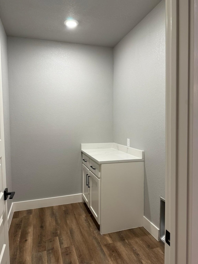 washroom featuring dark wood-style floors and baseboards