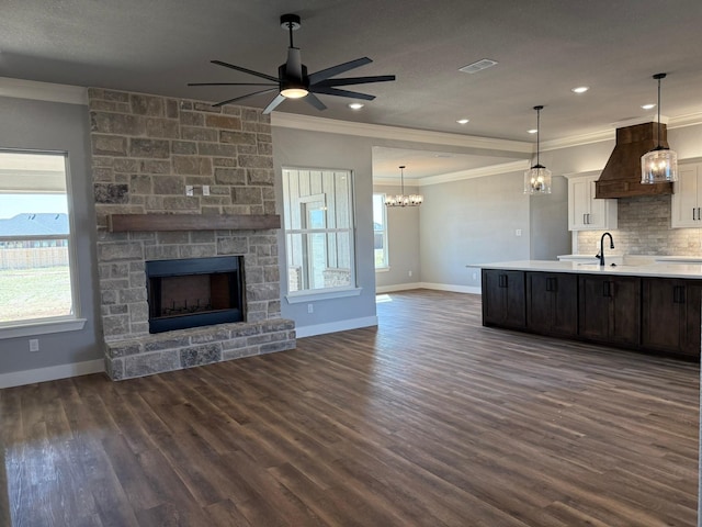 kitchen featuring open floor plan, light countertops, premium range hood, a fireplace, and white cabinetry