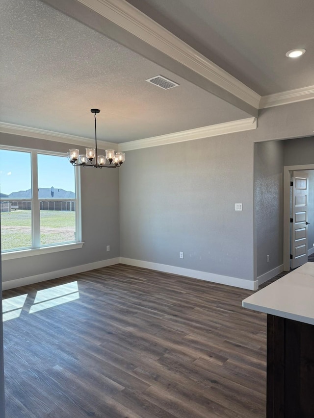 unfurnished dining area featuring dark wood finished floors, visible vents, crown molding, and baseboards