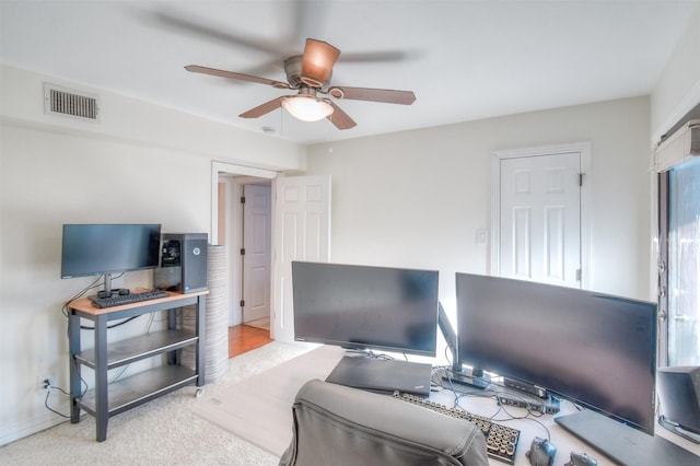 carpeted office featuring ceiling fan, visible vents, and baseboards