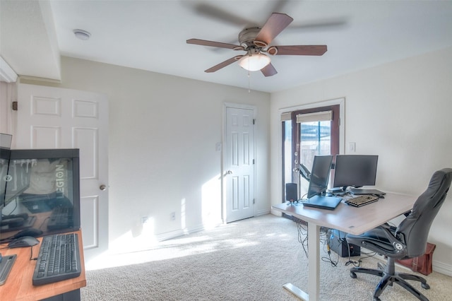 home office featuring carpet, ceiling fan, and baseboards