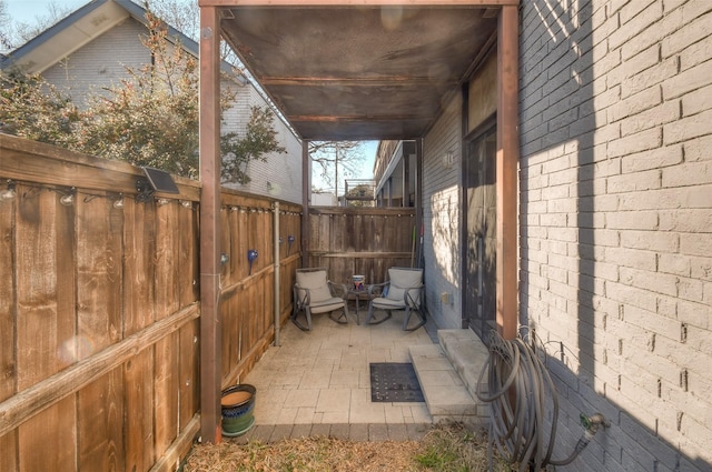 view of patio / terrace featuring fence