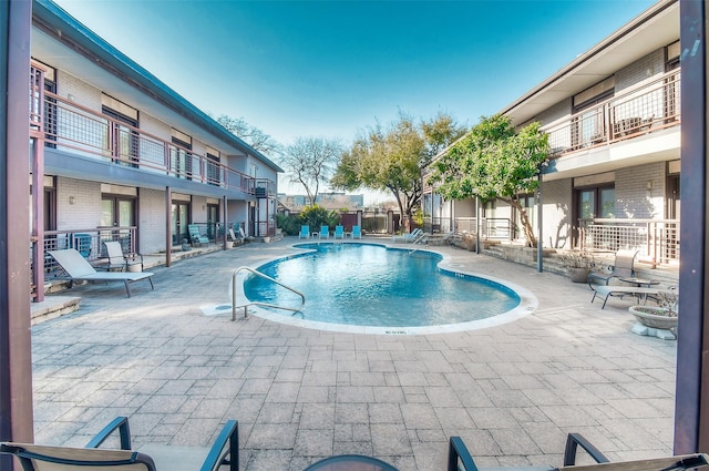 pool featuring a patio area and fence