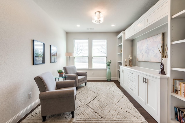 living area featuring baseboards, visible vents, dark wood-style flooring, and recessed lighting