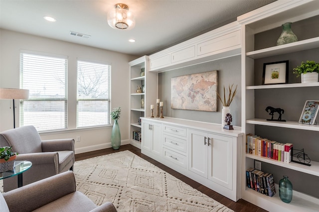 living area featuring built in shelves, recessed lighting, visible vents, baseboards, and dark wood-style floors