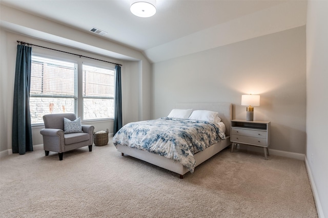 carpeted bedroom with baseboards, visible vents, and vaulted ceiling