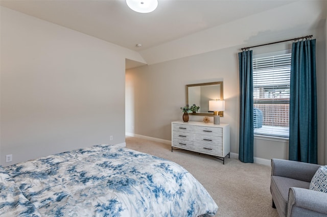 bedroom featuring light carpet, baseboards, and lofted ceiling