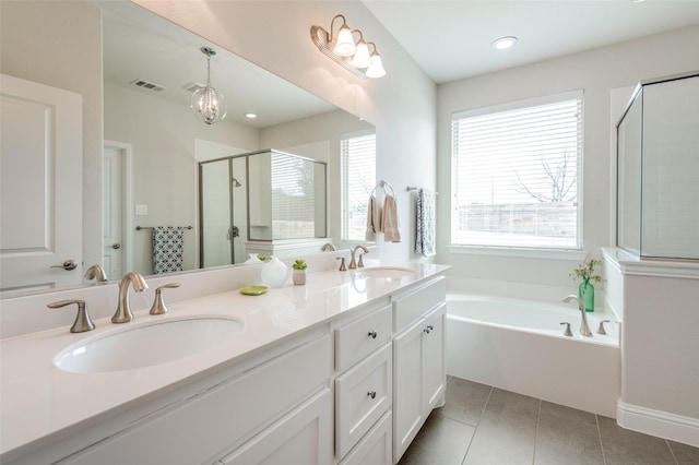 bathroom with double vanity, tile patterned flooring, a sink, and a shower stall