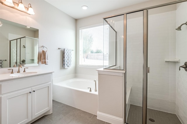 bathroom with a stall shower, a garden tub, vanity, and tile patterned floors