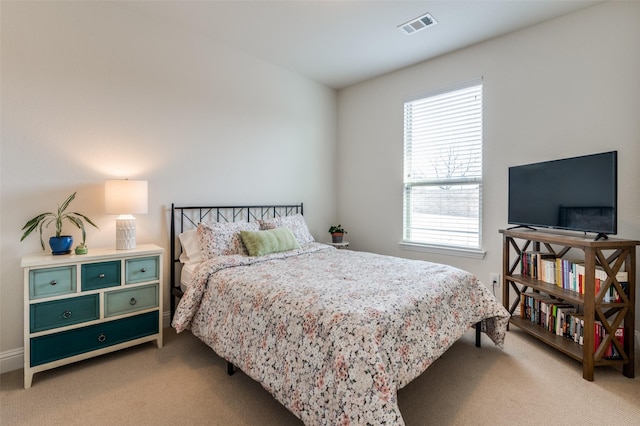 bedroom with light carpet and visible vents