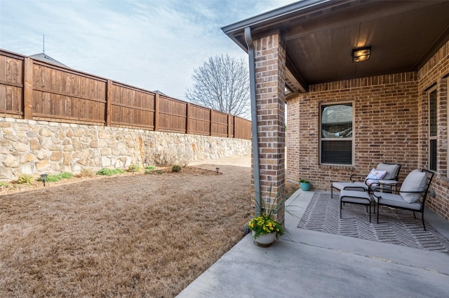 view of patio featuring fence