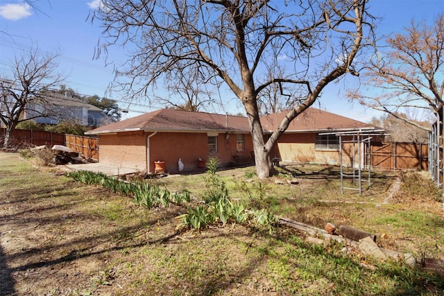 exterior space featuring brick siding and fence