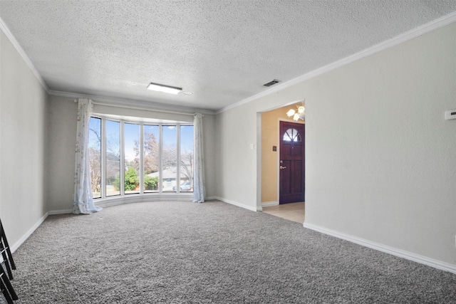 empty room with ornamental molding, baseboards, visible vents, and carpet flooring