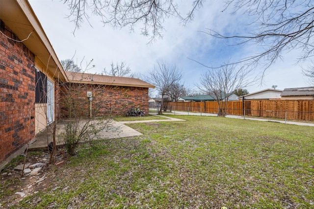 view of yard with a patio and a fenced backyard