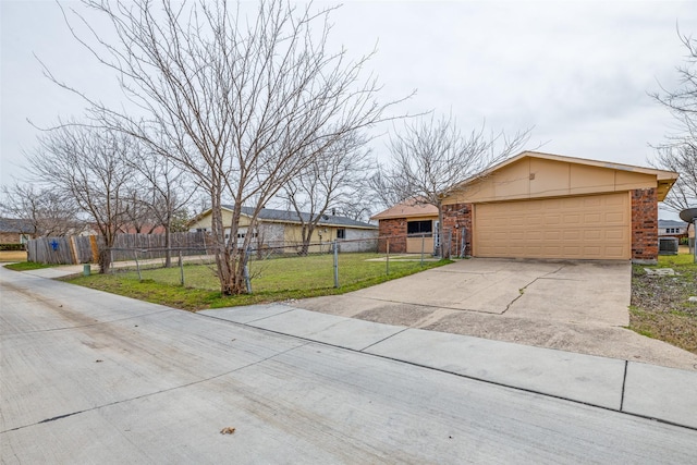 view of front of house with brick siding, a front yard, fence, a garage, and driveway