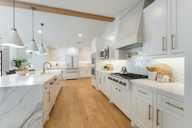 kitchen featuring light wood-style flooring, white cabinetry, a sink, white appliances, and premium range hood