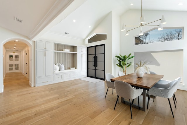 dining area featuring arched walkways, high vaulted ceiling, recessed lighting, visible vents, and light wood-style floors