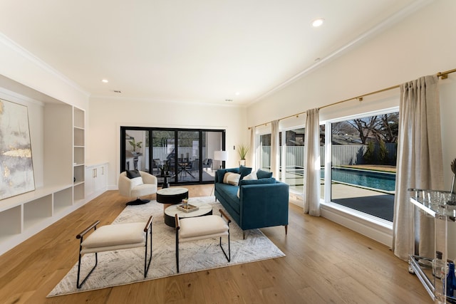 living room with ornamental molding, wood finished floors, and recessed lighting