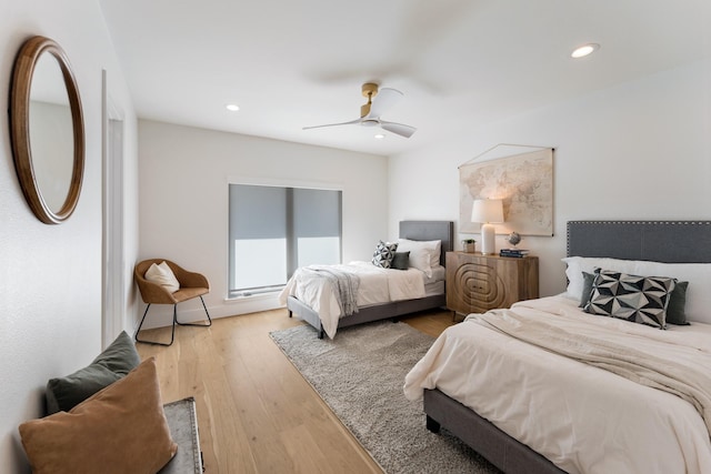 bedroom with ceiling fan, wood finished floors, and recessed lighting