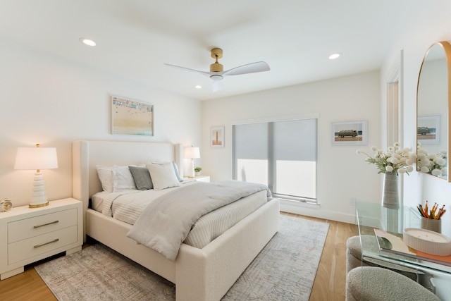 bedroom featuring light wood-style flooring, a ceiling fan, and recessed lighting