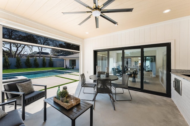 sunroom featuring wood ceiling and ceiling fan