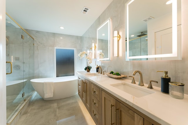 full bathroom featuring visible vents, tile walls, and a sink