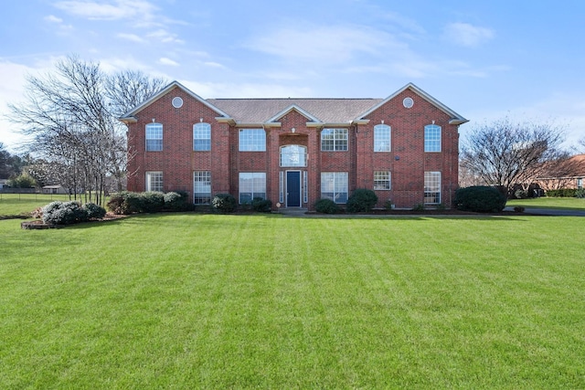 view of front of house with brick siding and a front yard