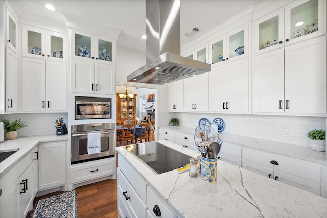 kitchen with visible vents, white cabinets, appliances with stainless steel finishes, and island range hood