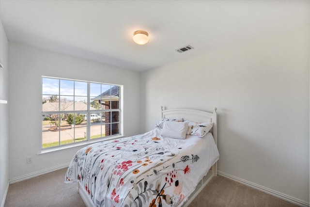 bedroom with visible vents, carpet floors, and baseboards