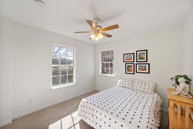 bedroom featuring ceiling fan, baseboards, and carpet floors