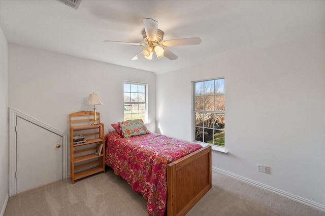 bedroom featuring a ceiling fan and light colored carpet